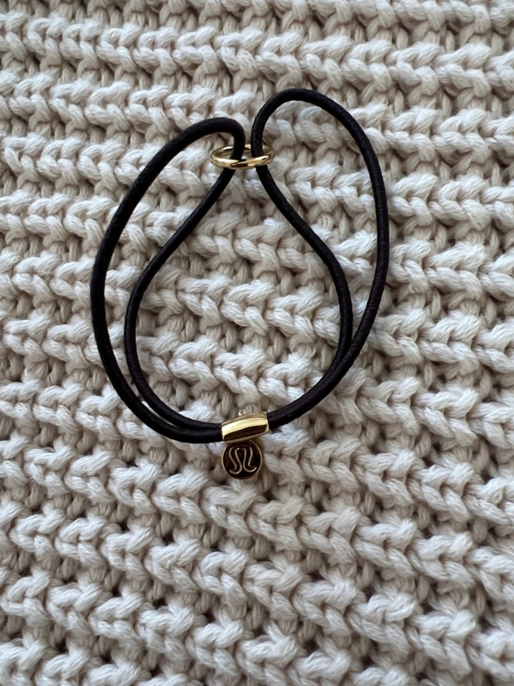 lululemon athletica black elastic bracelet with gold logo charm